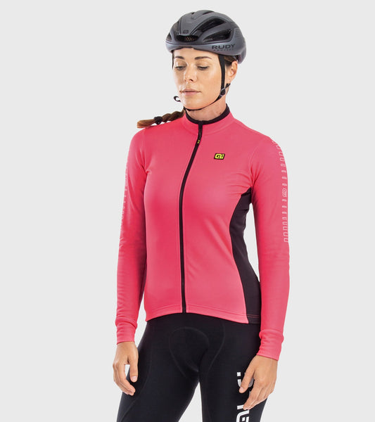 Person wearing a pink cycling jacket and black helmet on a light gray background